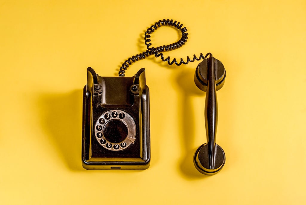 Black vintage phone on a yellow background | Humidifier services in Dallas, TX