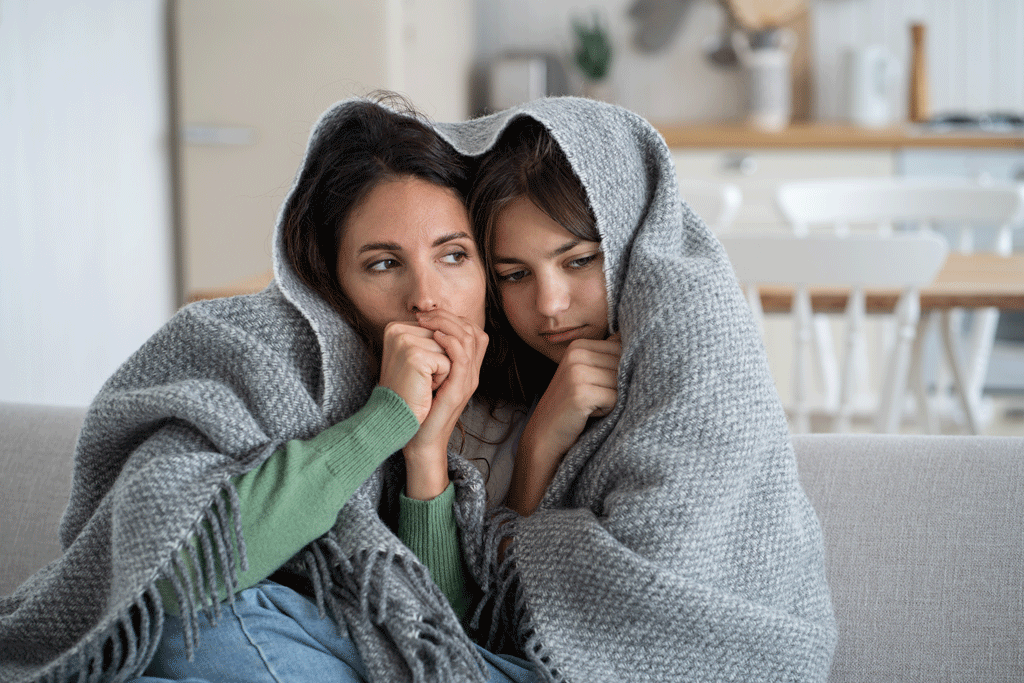 ladies sitting on the couch with blankets heating and ac repair allen tx addison tx 