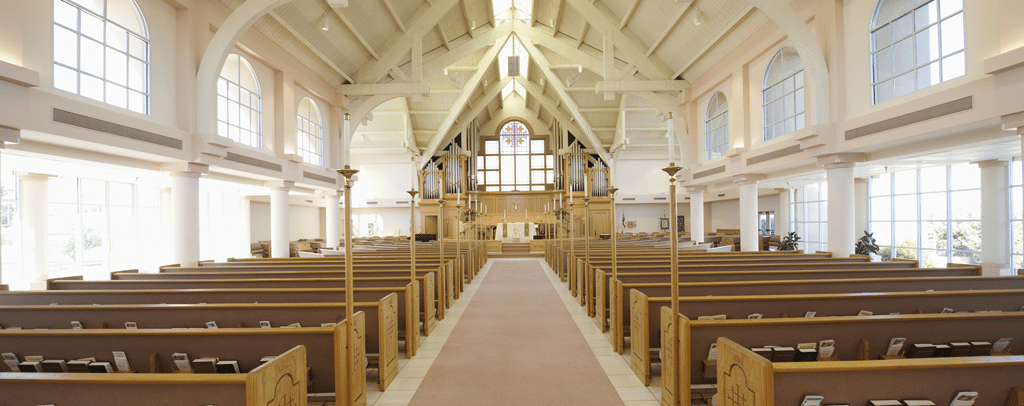 View of church interior down the center isle with a lot of natural light, windows, and pews | Church HVAC in Dallas, Plano, & Frisco TX