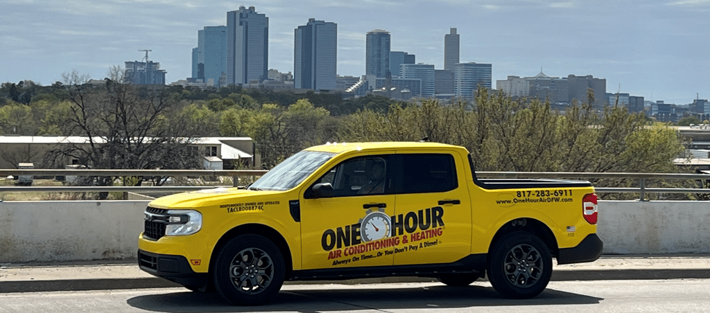 One Hour Air Conditioning & Heating of Dallas, TX truck parked on road in front of city skyline 