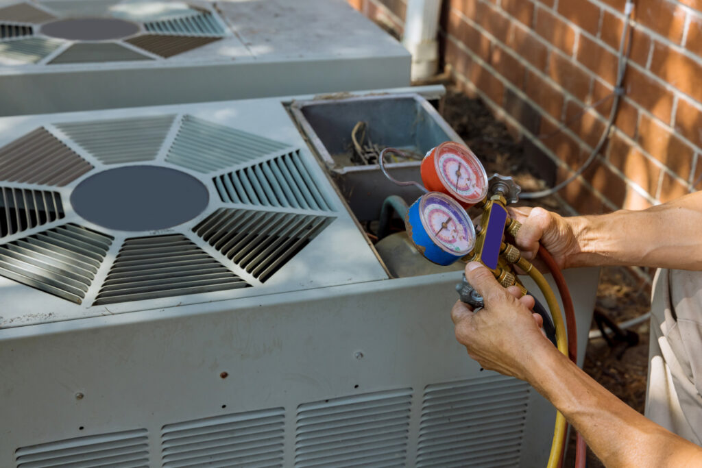 An air conditioning technician is servicing or preparing to service an air conditioner.
