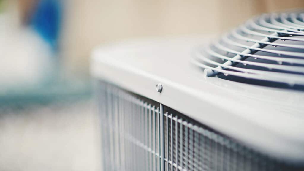 An air conditioner unit in a residential garden, part of the residential HVAC system.