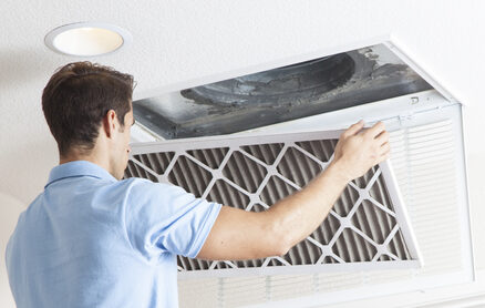 A man cleaning air ducts in a home. The ductwork, the circulatory system of your HVAC.