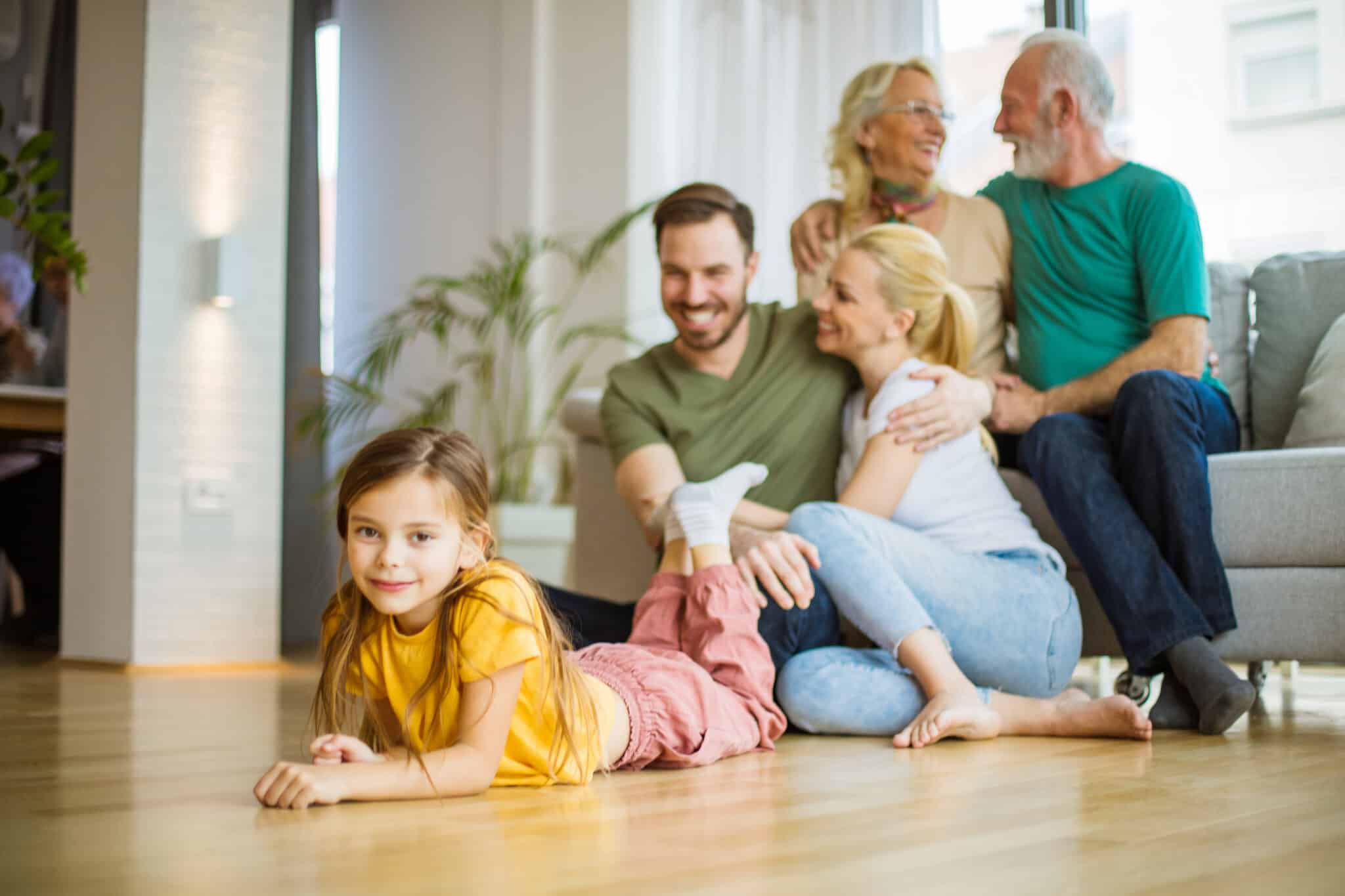 Family relaxing together at home, High-Capacity HVAC System.